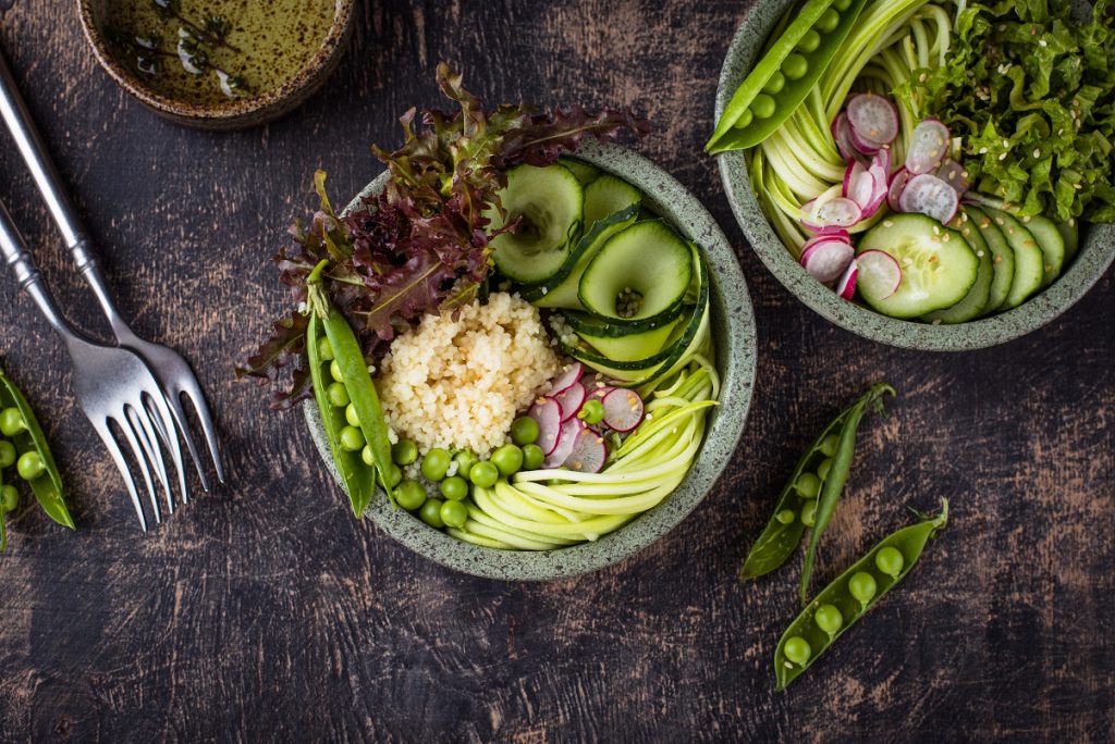 Vegan healthy green buddha bowl with peas, cucumber, salad and zucchini